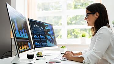 Woman staring at data on a computer